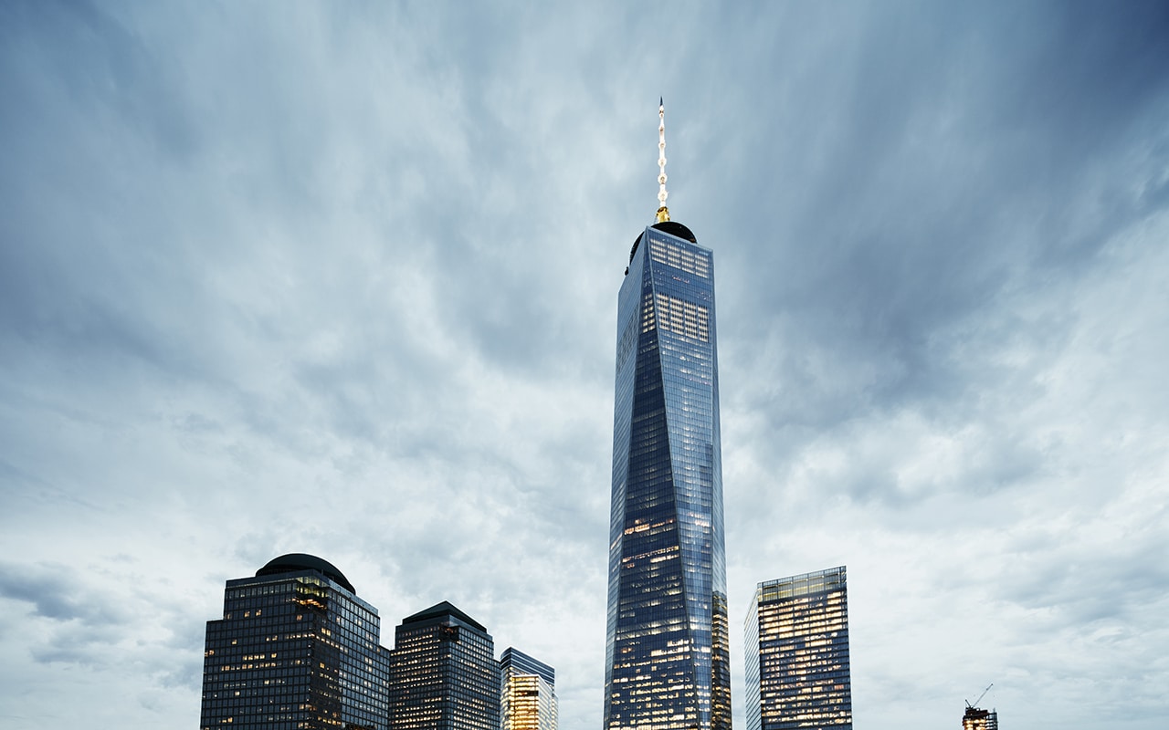 a low-angle shot of skyscrapers under a cloudy sky